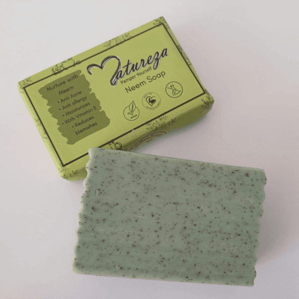 Neem soap with and without packaging are displaying on the plain surface.