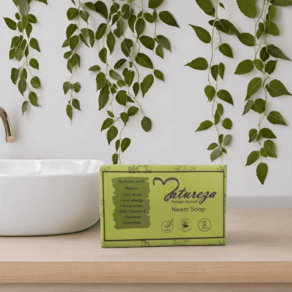 Natureza Neem soap is in the bathroom settings near the washing basin and neem leaves are hanging behind it.